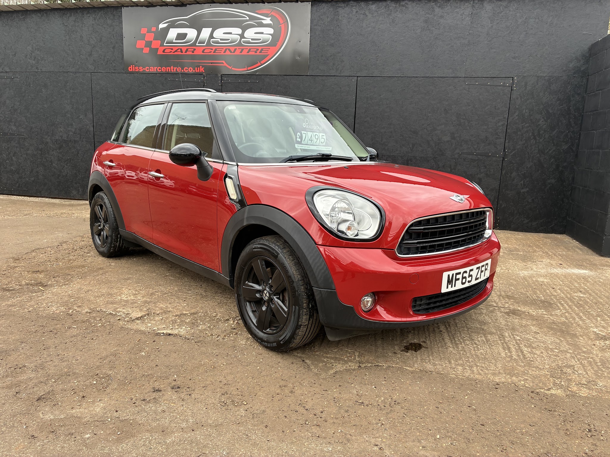 Red MINI Countryman in front of the Diss Car Centre sign